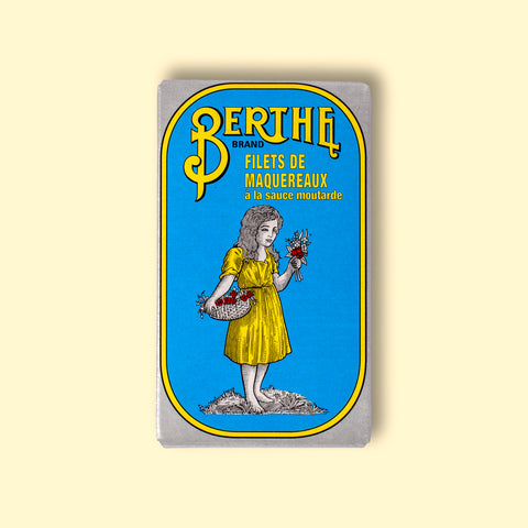 A bright blue tin with Berthe written in yellow lettering above an image of a little girl holding a bunch of flowers and wearing a yellow dress.