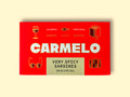 Bright red box with very spicy sardines from Carmelo, a premium tinned fish brand. The box is covered with golden illustrations like a pair of sunglasses, a book, a wine glass, a suitcase and a fish.