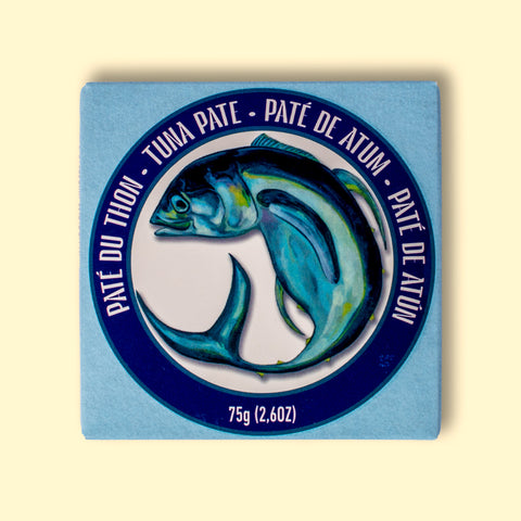 Tuna pate in a card box with blue label and fish illustration on a pale yellow background