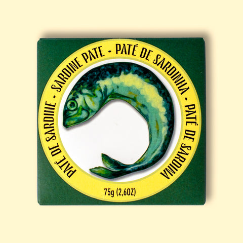 Box of Sardine spread on a yellow table. The box has an illustration of a fish