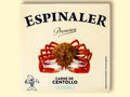 A tin of spider crab meat in square-shaped, cream-coloured card packaging with a picture of a 10-legged spider crab beneath the Espinaler logo in blue lettering. The can is against a pale yellow background.