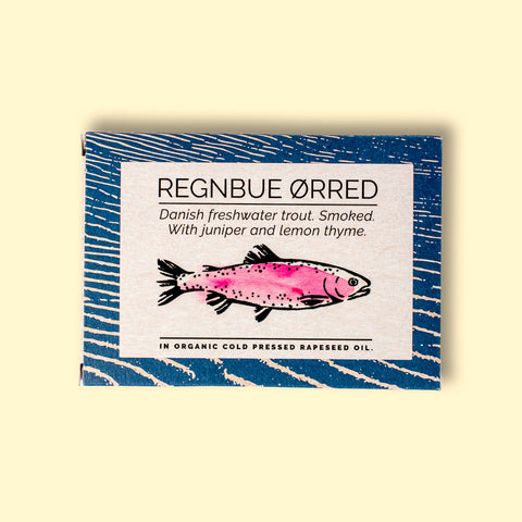 A tin with a blue border and a drawing of a trout coloured pink on the front
