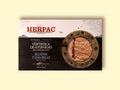 A tin of bluefin tuna belly in rectangular card packaging. The Herpac logo is written in red lettering above an ink-black sea with seagulls flying above it. There is a golden porthole on the right hand side of the packaging through which you can see the glistening bluefin tuna belly.