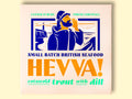 Box containing Cotswold trout with dill from Hevva! The box is illustrated with a fisherman calling out over the Cornish coast with cliffs and a lighthouse in the background. The box is colourful with Hevva! written in golden, embossed letters