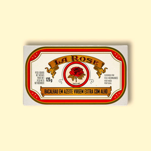 A tin of cod in white packaging with a red border, and an image of a red rose on the front below La Rose written in red lettering on a gold banner