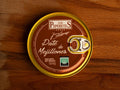 A circular tin of mussel pâté with a gold-coloured border, a silver ring pull, and a reddish brown label with the Los Peperetes logo at the top and pate de mejillones written in white lettering beneath it.