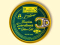 A tin of boneless sardines in green packaging with golden borders, featuring the Los Peperetes label at the top, set against a pale yellow wooden backdrop. 