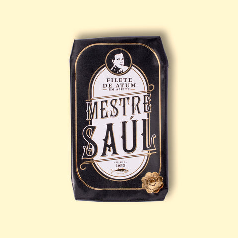 Tuna fillets from the brand Mestre Saul, packed into a tin wrapped in sleek black paper with a gold border.