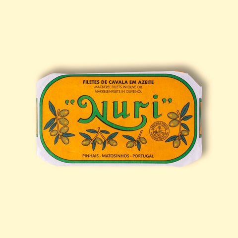 Mackerel fillets in an orange wrap with a white and green border. Nuri is written in green lettering above some small olive branches.