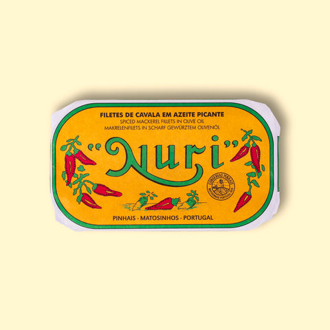 Mackerel in spicy olive oil in an orange paper wrap with a green and white border, and Nuri written in green lettering above some red chilli peppers