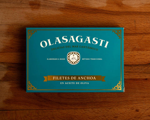Olasagasti anchovy fillets blue packaging on a wooden surface