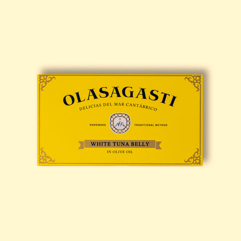 A tin of white tuna in olive oil, packaged in a yellow rectangular box featuring the brand name Olasagasti. 