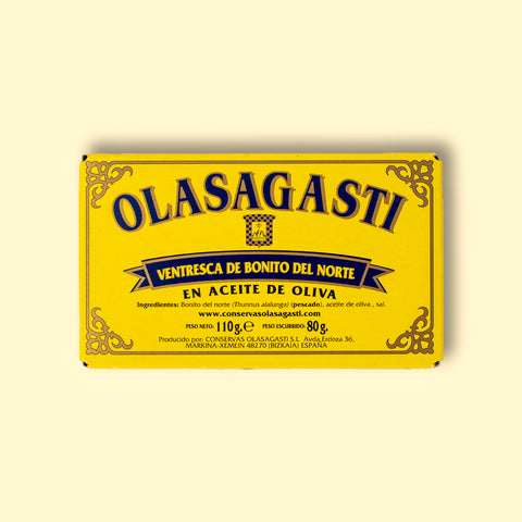 A tin of tuna belly in a rectangular yellow box with blue lettering and a gold border. 