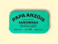 A tin of sardines in organic extra olive oil in light green packaging, featuring the Papa Anzóis brand name at the top. 