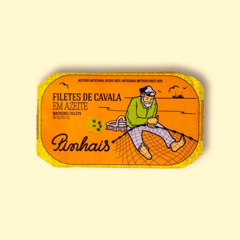 Mackerel fillets in an orange wrap with a yellow border. There is a drawing of a fisherman mending a fishing net on the front.
