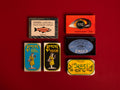 A selection of colourfully-packaged tinned 
sardines, tuna, mackerel, salmon and mussels against a red background.
