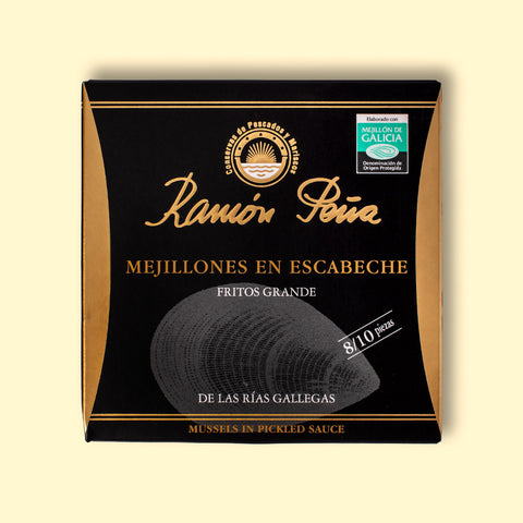 A tin of mussels in black card packagaing with a gold border and an image of a mussel drawn on grey on the front. The tin is on a pale yellow background. 