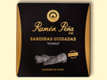 A tin of small sardines in black and gold packaging. Ramón Peña is written in gold lettering above a silver grey image of a sardine