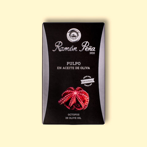 A tin of Ramon Pena octopus in olive oil, in black card packaging featuring an illustration of octopus tentacles on the front. 