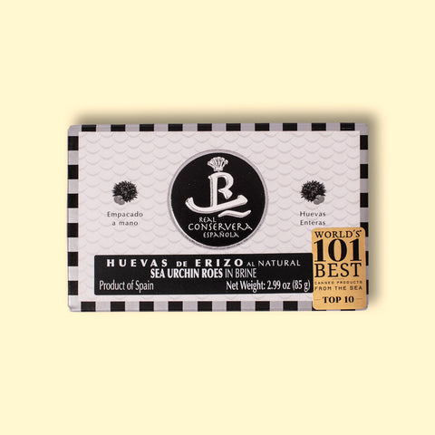 A rectangular tin of sea urchin roe in brine, with white and black packaging, displaying sea urchin illustrations next alongside the Real Conservera logo.
