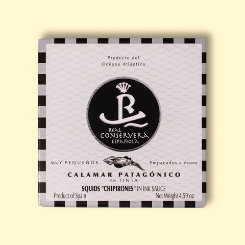 Squid in black and white card packaging with silver and black borders, featuring a central illustration of a squid. 