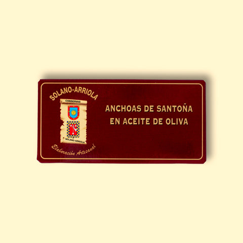 Solano Arriola small anchovies in a burgundy box with gold writing and traditional coat of arms illustrations. 