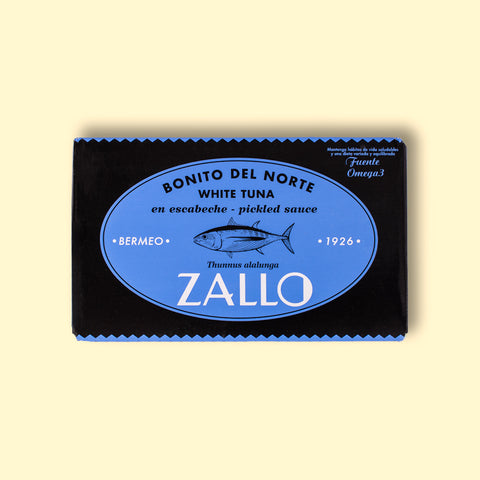 A rectangular tin of tuna with blue and black packaging with a drawing of a tuna fish on the front and Zallo written in white lettering