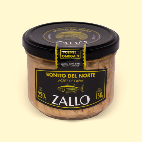 A jar of tuna fillets in olive oil with black and yellow labelling