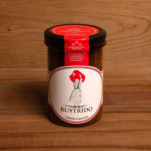A jar of salsa with a red and white label and a drawing of a woman carrying a large red pepper on her head.