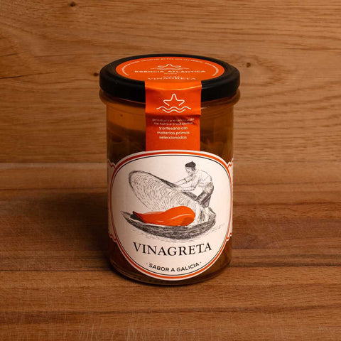 A jar of salsa with an orange and white label. There is an image of a man opening a giant mussel shell on the label.