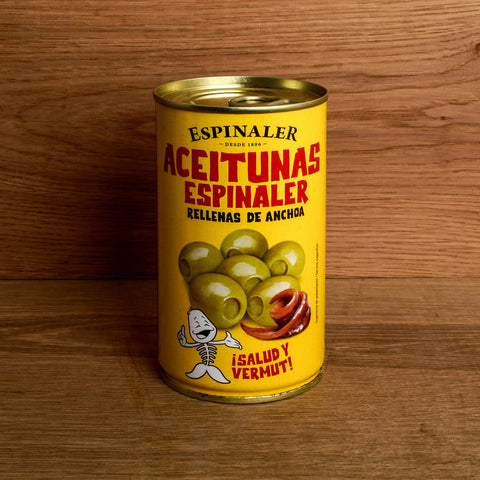 A yellow tin of olives, with an image of green olives and an anchovy fillet on the front, and Aceitunas Espinaler in red lettering written at the top.