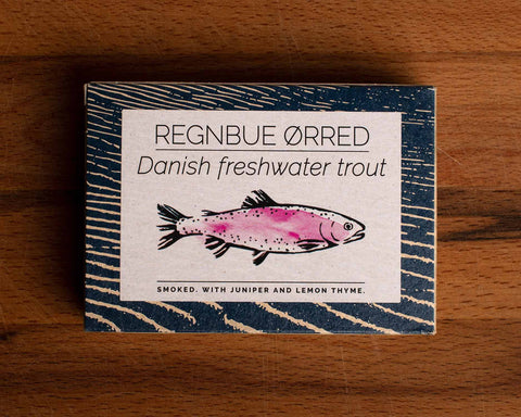 A tin with a blue border and a drawing of a trout coloured pink on the front
