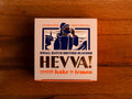 A square box with an image of a fisherman calling out over the Cornish coast. The packaging has a light background with purple, orange and gold lettering.