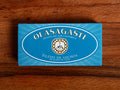 A tin of anchovies in light blue packaging with Olasagasti written in white lettering, on a wooden background 