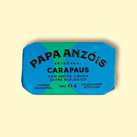 A tin of horse mackerel in organic extra virgin olive oil, with Papa Anzois labeled on top, presented in light yellow and green rectangular packaging. 