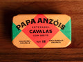 A tin of mackerel in olive oil from Papa Anzois, inside a brightly coloured orange, red and green packaging. 