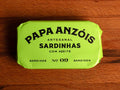 A tin of sardines in olive oil in lime green packaging, featuring the Papa Anzois brand name on top. 