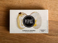 A tin of clams in white packaging with an image of an open clam with the Pepus logo on the front 