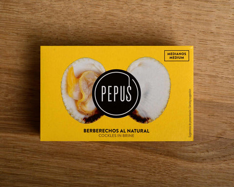 A tin of cockles in yellow card packaging with an image of an open cockle and the round Pepus logo on the front