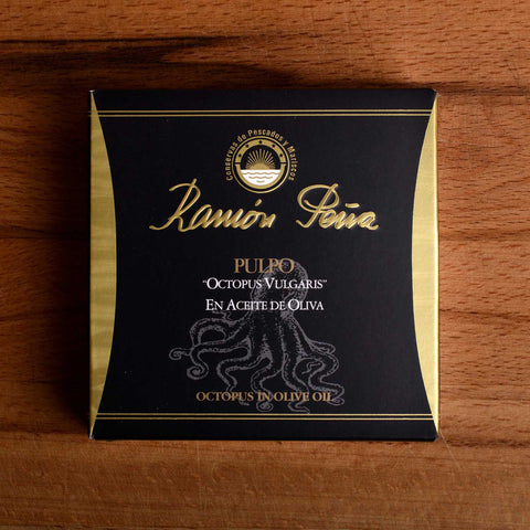 Tinned octopus in black and gold packaging. Ramón Peña is written in raised gold lettering above a silver grey image of an octopus on the front of the packaging.