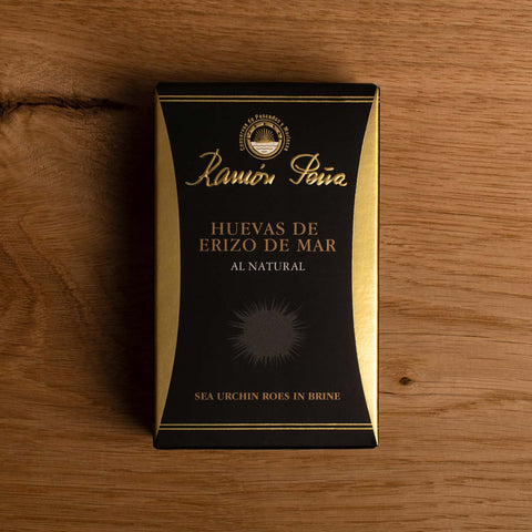 Black and gold rectangular box with Ramón Peña written in gold above a grey image of a sea urchin.