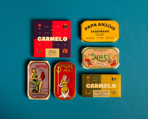 Collection of premium tinned fish in colourful wrappers. One of them is a sardine with lemon, another is the stew sardines from Nuri and also de smoked oysters from Carmelo