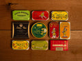A selection of colourfully-packaged tinned fish against a wood back drop