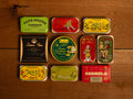 A selection of colourfully-packaged tinned fish against a wood back drop