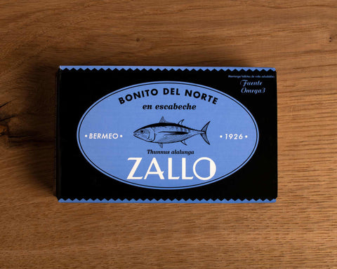 A rectangular tin of tuna with blue and black packaging with a drawing of a tuna fish on the front and Zallo written in white lettering