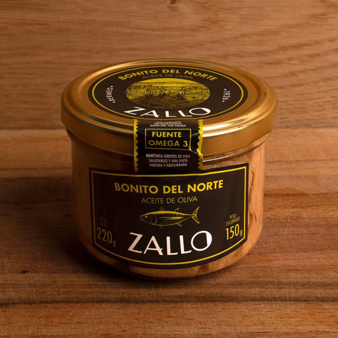 A jar of tuna fillets in olive oil with black and yellow labelling